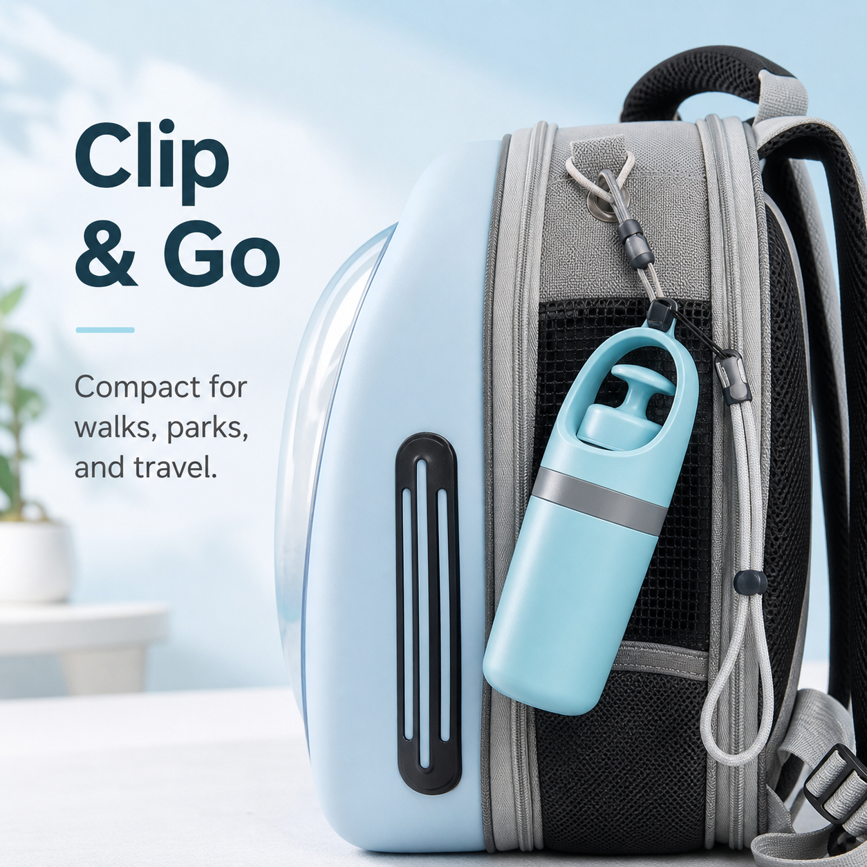 Portable dog poop scooper clipped to pet travel bag